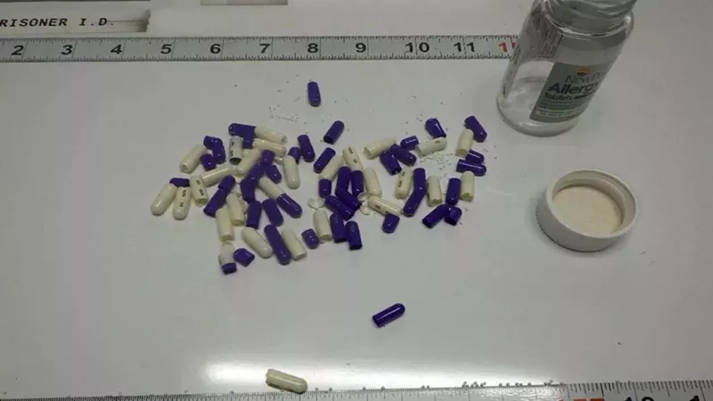 An evidence photo displays pills that were confiscated from a Michigan Department of Corrections prisoner. A source with knowledge of drug activity within MDOC says the pills were coated with fentanyl.