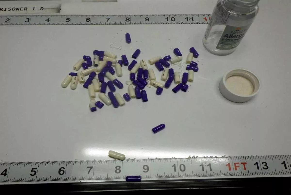 Image: An evidence photo displays pills that were confiscated from a Michigan Department of Corrections prisoner. A source with knowledge of drug activity within MDOC says the pills were coated with fentanyl.