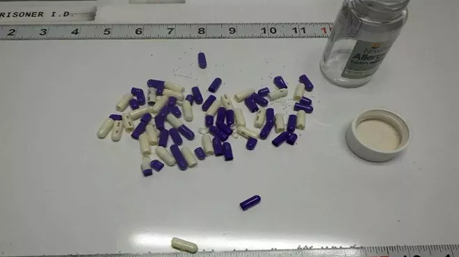 An evidence photo displays pills that were confiscated from a Michigan Department of Corrections prisoner. A source with knowledge of drug activity within MDOC says the pills were coated with fentanyl.