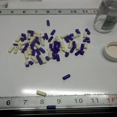 An evidence photo displays pills that were confiscated from a Michigan Department of Corrections prisoner. A source with knowledge of drug activity within MDOC says the pills were coated with fentanyl.